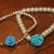 Set bracciali elastici con perle color avorio e argento e rosa azzurra