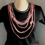 Personalized black xl size short sleeve woman's t-shirt with hand knitted pink application.