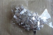 100 terminali fermafili zigrinati metallo color argento 7 mm.