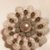 Spilla in lana color panna fatta a mano realizzata ad uncinetto e decorata con perle nella parte centrale 
