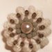 Spilla in lana color panna fatta a mano realizzata ad uncinetto e decorata con perle nella parte centrale 