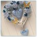 Cuore/fiocco nascita in vimini con roselline,rametti ,cuori azzurri e due farfalle gialle