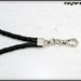 cinturino staccabile da polso in vero cuoio intrecciato,  lunga 21 Cm.  colore nero con rifiniture colore argento 