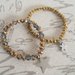 Bracciali oro e bronzo con charms