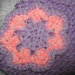 Hand knitted lilac and pink flower hat