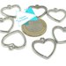 7 charms argentati a forma di cuore.