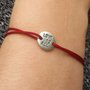 Bracciale di corda con pendente charm in argento Love is all, fatto a mano