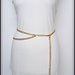 Cintura a catena oro con ciondolo cuore, si può indossare sia sui fianchi che in vita, taglia L - 95 cm.