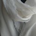 Pashmina in caldo cotone di colore bianco con delicato merletto lungo i lati.