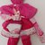 Originale bambolina formata da asciugapiatti di spugna sui colori rosa/fucsia e presine di cotone decorata con delicato pizzo ricamato.