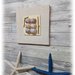 "la casa del mare" quadro con legni di mare e conchiglie