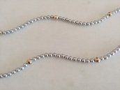 Delicata collana realizzata con perline color argento intervallate da perle più grandi brillantinate e sfaccettate