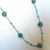 Collana medio-lunga ad uncinetto con cristalli, fatta a mano. Filato di colore verde giada, cristalli argento, verde ,bianco trasparente.                                           