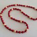 Collana realizzata con perle rosse ed inserti di perle  di legno chiaro e perline in legno scuro