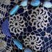 Collana di lunghezza media manufatta di ceramica con paline olive e mezzaluna con motivi incisi nei toni del blu 