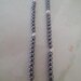 Collana realizzata con perle grigie alternate da perle filigranate color argento