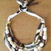Collana multifilo girocollo regolabile realizzata con 4 fili di fettuccia di cotone fantasia e filo di perle di legno marroni rivestite in carta