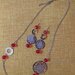 Orecchini e collana in metallo argentato nichel free con filigrana color argento e oro perle in cristallo sfaccettato colore rosso
