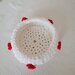 Delicato cestino realizzato a uncinetto in lycra bianca con roselline di pannolenci rosse intorno