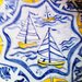 Piatto decorativo murale o appoggiato su porta piatto di ceramica dipinto a mano con motivo di barche al centro