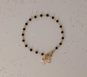Bracciale stile rosario realizzato a mano colore oro, cristalli neri e fiocco bianco