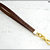 cinturino staccabile da polso,  lungo 21 Cm. in vero cuoio marrone inciso, finiture colore oro