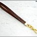 cinturino staccabile da polso,  lungo 21 Cm. in vero cuoio marrone inciso, finiture colore oro