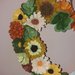 Ghirlanda con coccinella e fiori di feltro