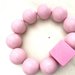 Bracciale elastico con perle colorate rosa