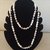 Delicata collana  a due giri, realizzata con perle tradizionali, alternate  da perle e perline argento eperlebianche trasparenti sfaccettate