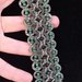 Bracciale celtico al chiacchierino nei toni del verde scuro con filo metallizzato e cristalli in tinta