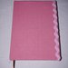 Agenda del nuovo anno- foderata ia mano con  tessuto di  ctone di colore rosa decorata con passamaneria zig zag in tinta