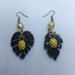 Orecchini pendenti asimmetrici con foglie tropicali nere in resina e charms in ottone a forma di ananas e cristalli gialli