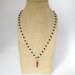 Collana girocollo stile rosario realizzata a mano con filo di colore argento, cristalli neri e cornetto rosso portafortuna.