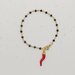 Bracciale stile rosario realizzato a mano di colore oro, cristalli neri e cornetto rosso portafortuna.