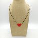 Collana girocollo stile rosario realizzata a mano con filo colore oro, cristalli neri e cuore rosso.