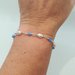 Bracciale stile rosario realizzato a mano con filo colore argento, cristalli azzurri e perle bianche.