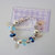 BRACCIALE CON PERLE E CHARM A FORO LARGO. BR.AC_035