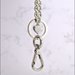 Catena per borsa, diamantata colore argento lunga cm. 115, completa di anelli, moschettoni  e ciondoli cuore.