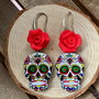 Orecchini ‘teschio messicano’  in legno dipinto a mano con rosa in pasta polimerica e monachella in ottone argentato