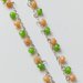Collana girocollo argentata con mezzi cristalli 4x6 mm color verde chiaro ed arancio.