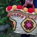 Coffa "Filomena" realizzata ad uncinetto con pompon, dipinta a mano