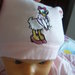 cappellino neonata con ricamata paperina