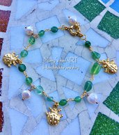 Bracciale a rosario con pietre dure verdi, ciondoli coccinella in zama e perle di fiume