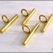 4 barrette con anello, in metallo colore oro, lunghezza mm. 30 