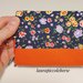Portachiavi / portamonete / tessere in stoffa fantasia fiori e arancione con zip e nappina