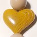 Collana con perle beige e cuore giallo ocra.