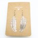 Orecchini pendenti di Piuma in metallo colore argento con monachelle in Acciaio inox - WME10