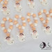 bomboniera rosario con corce e angelo bicolore arancio e bianco con cuore impresso personalizzabile