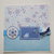 Biglietto Natale azzurro con uccellino e fiocchi di neve
